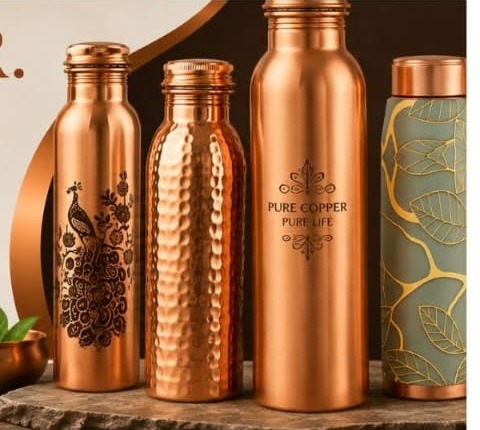 Artisan hand-hammering a copper bottle